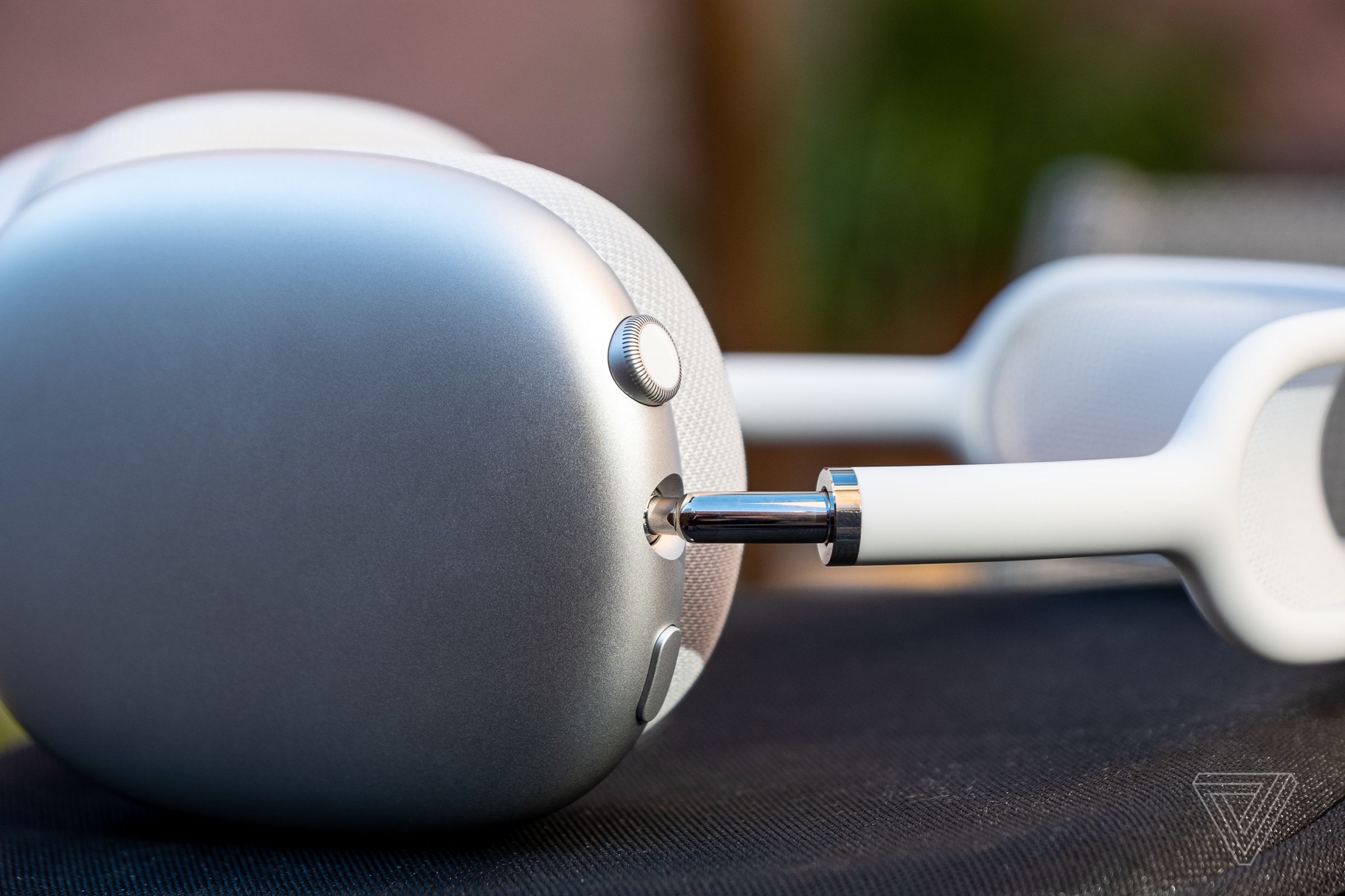 A close-up of the Digital Crown on Apple's silver AirPods Max headphones.