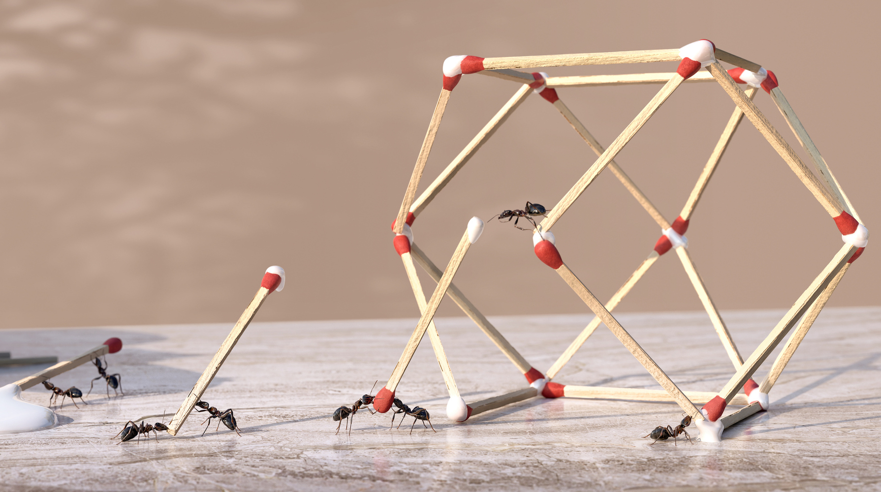 A group of ants working as a team to form a three-dimensional geometric sculpture from glue and matches.  The ants dip the ends of matchsticks in glue dripping from a bottle of glue and are placed in position to form the shape on a marble worktop.