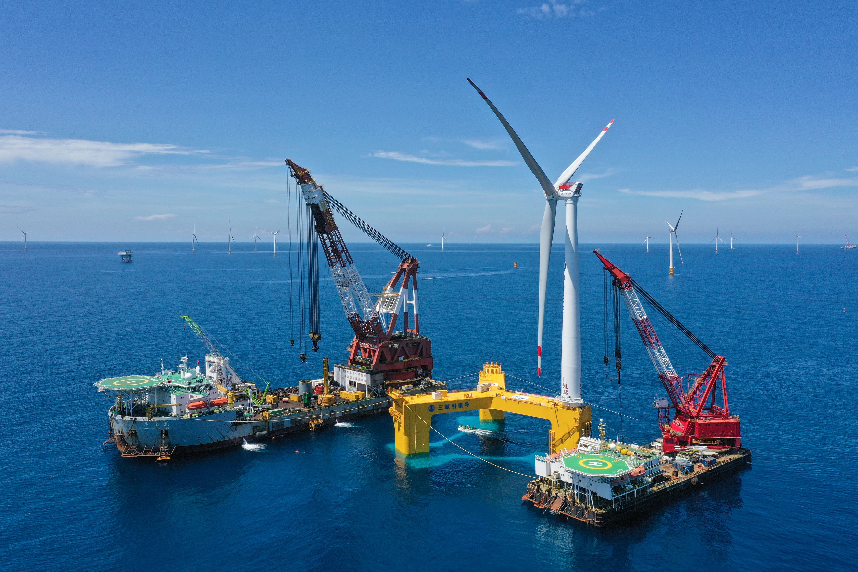 Ships assembling a floating offshore wind turbine